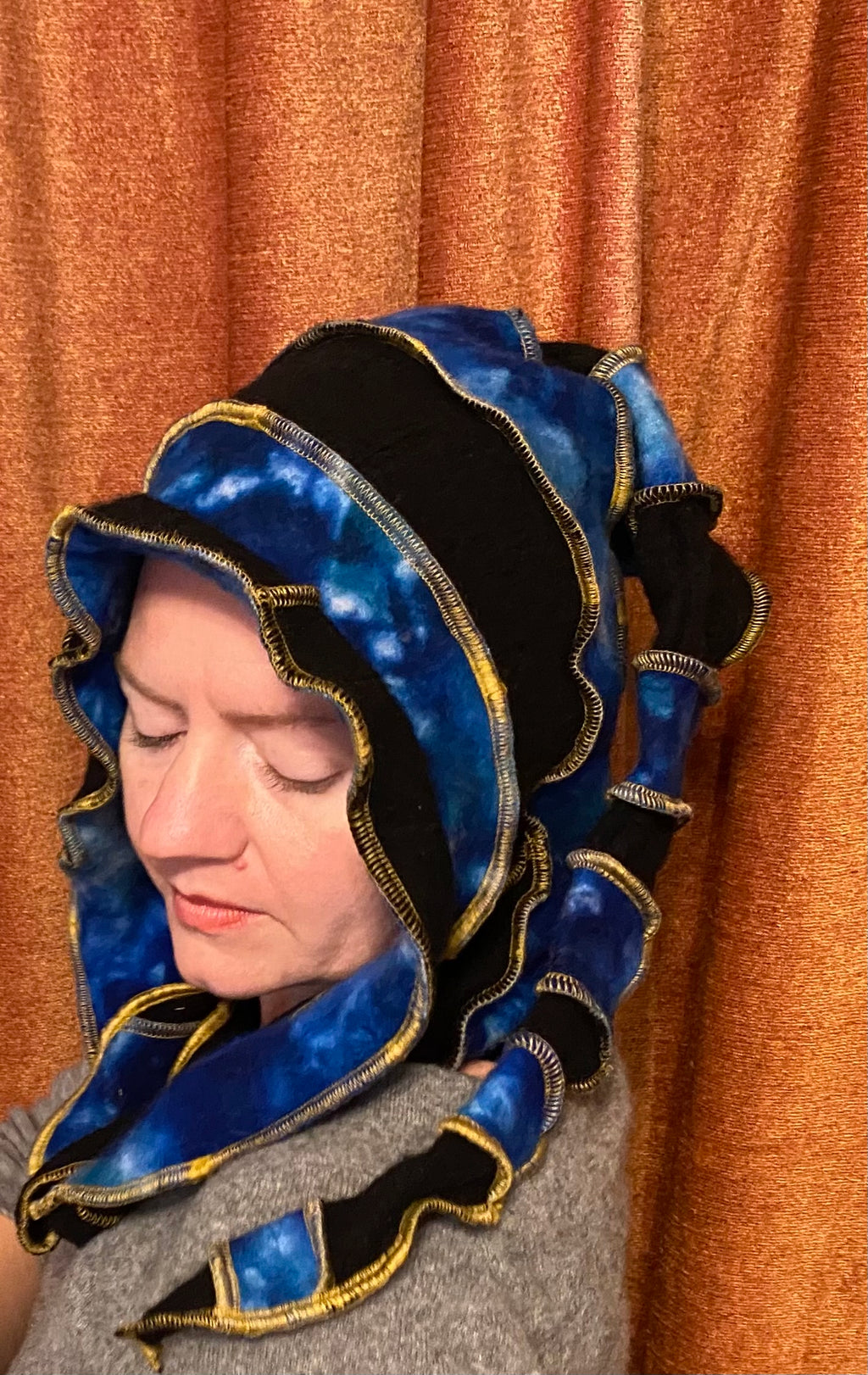 Marbled blue cashmere and black hood with gold thread accents